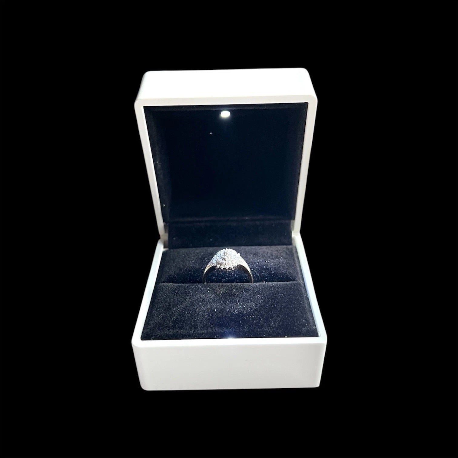 Diamond ring in a white box on a black background