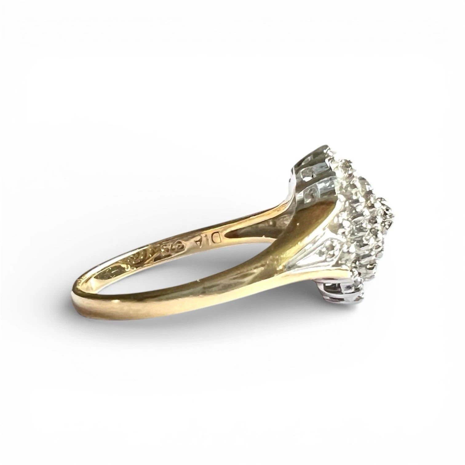 Gold ring with a diamond on a white background, close up side view of gold band and setting 