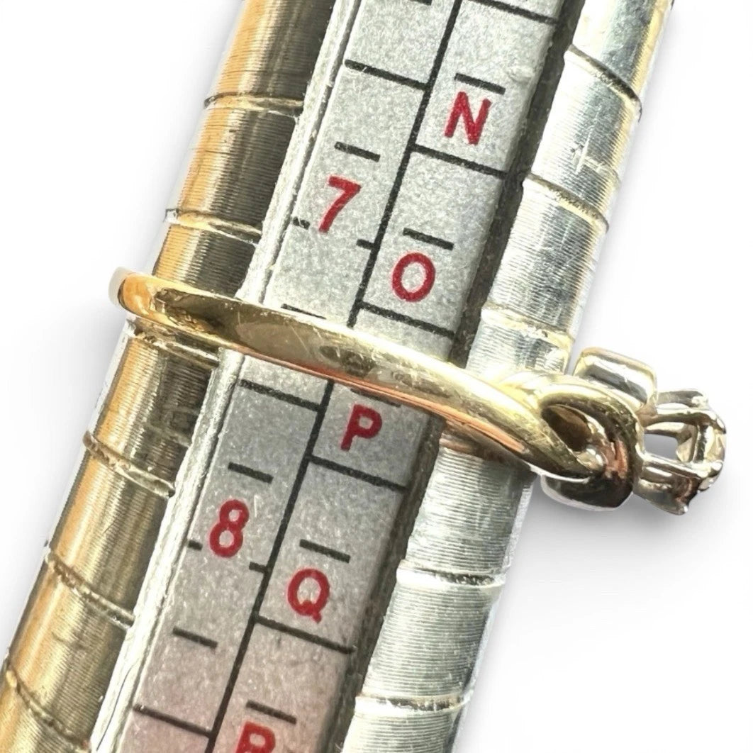 Close-up of a silver measuring tool with fold ring on a white background