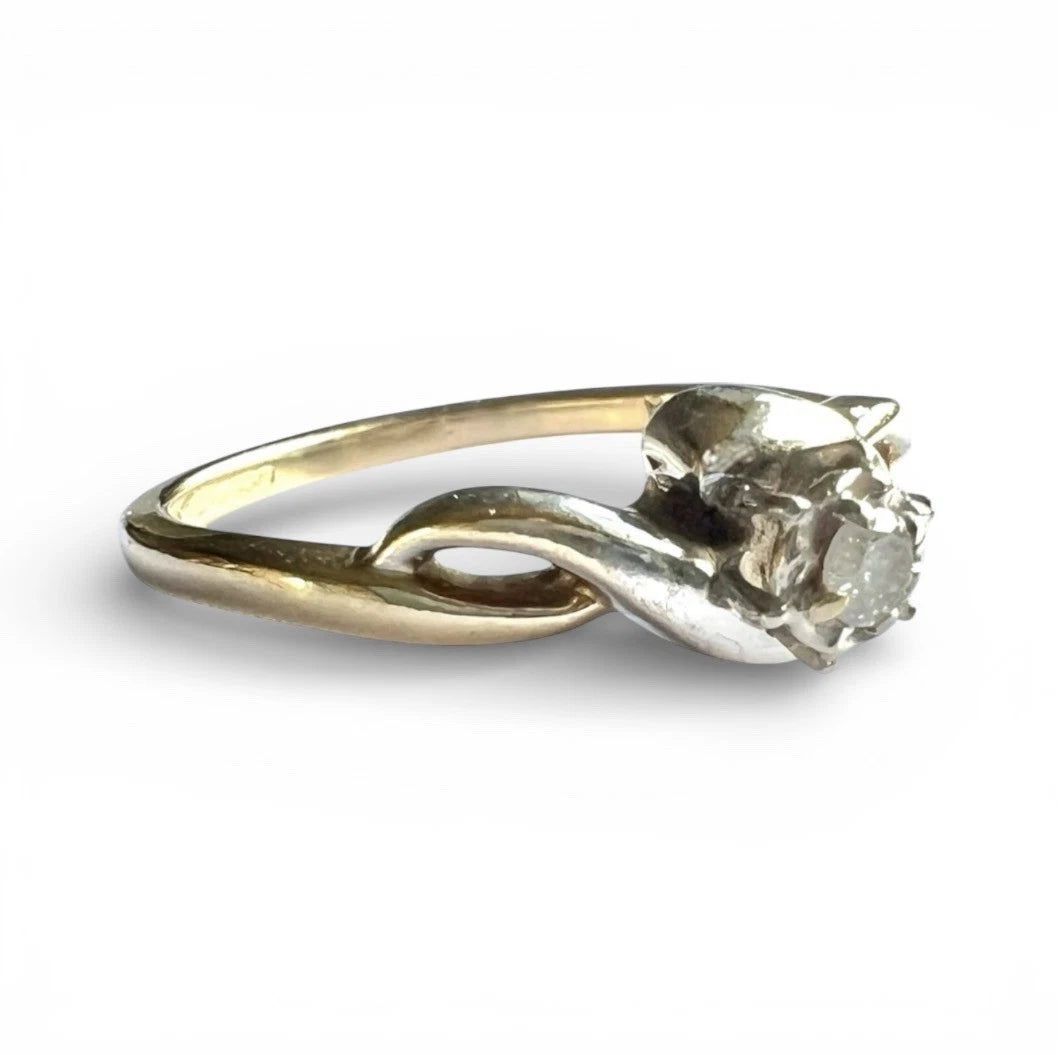 Gold ring with a diamond on a white background