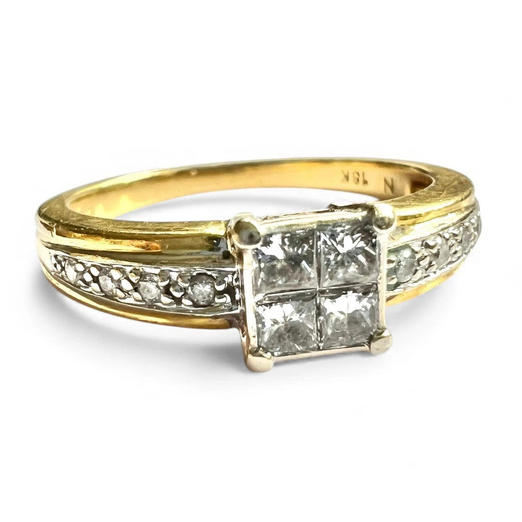 Gold ring with princess cut diamonds on a white background. Close up front view 