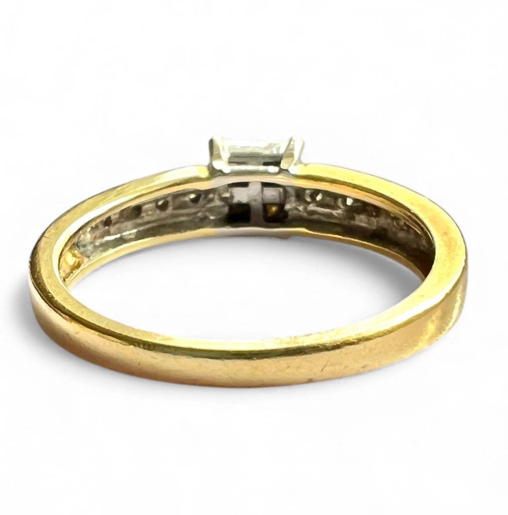 Gold ring with diamonds on a white background, close up rear view of setting and gold band 