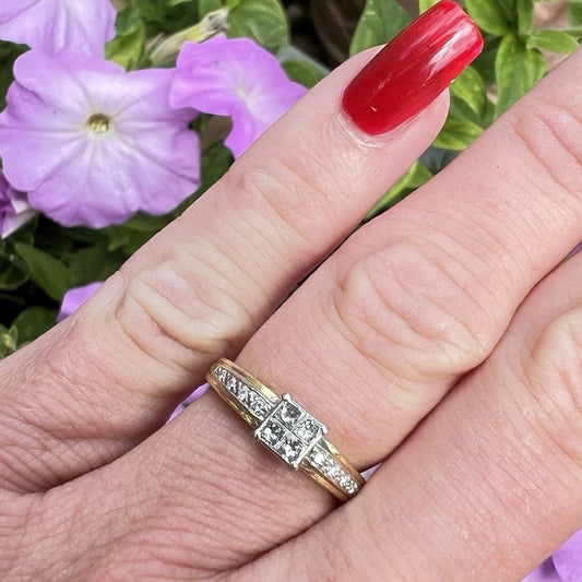 Gold ring with diamonds on a finger against a floral background