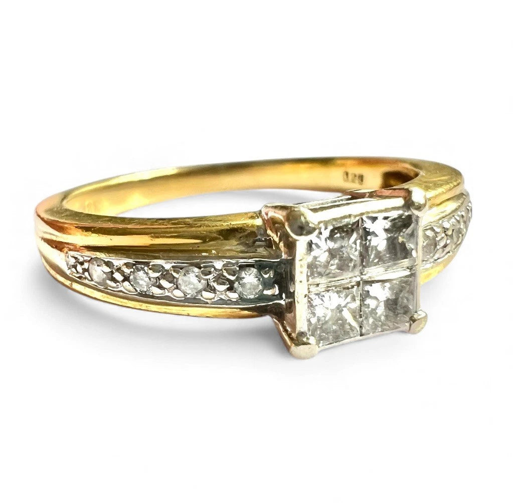 Gold ring with diamonds and smaller diamonds on a white background
