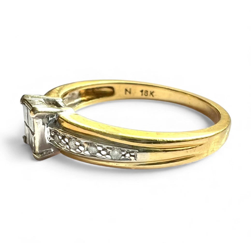 Gold ring with a diamond on a white background, close up side view 