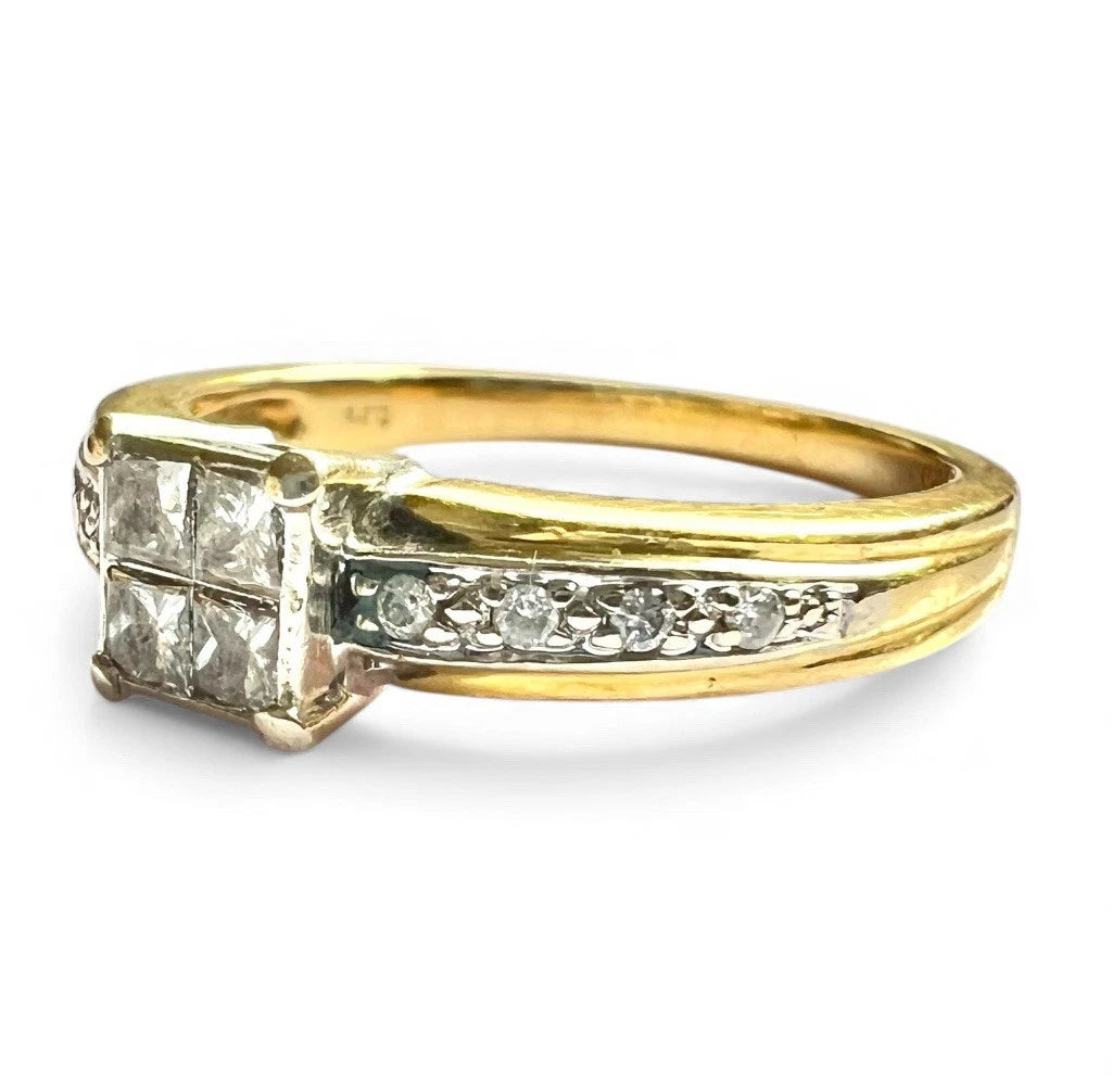 Gold ring with princess cut diamonds and diamond accents on a white background close up 