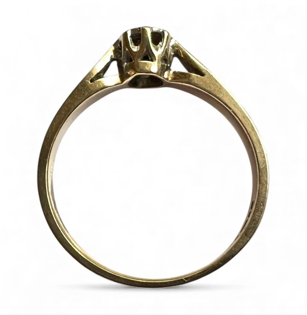 Gold ring with a diamond on a white background