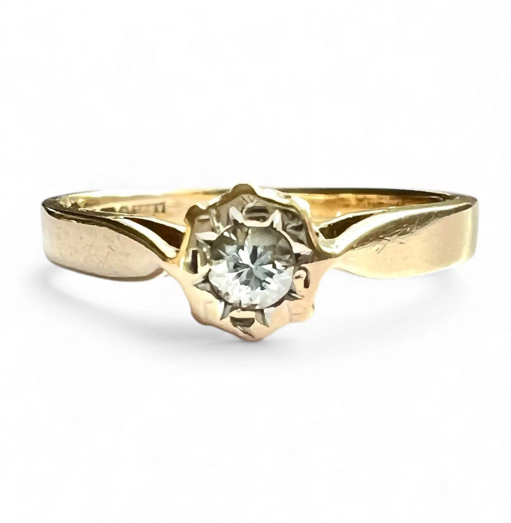 Gold ring with a diamond on a white background. Close up front view 