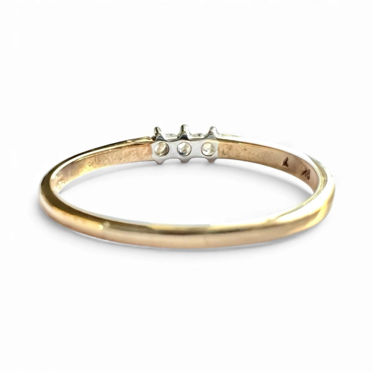 Gold ring with small diamonds on a white background. Close up rear view 