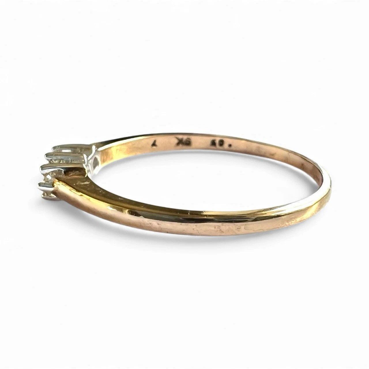 Gold ring with three diamond on a white background