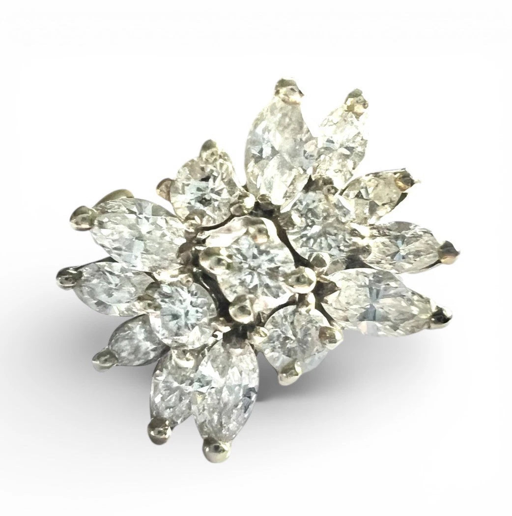 Diamond cluster ring with marquise-shaped diamonds on a white background. Close up front view 