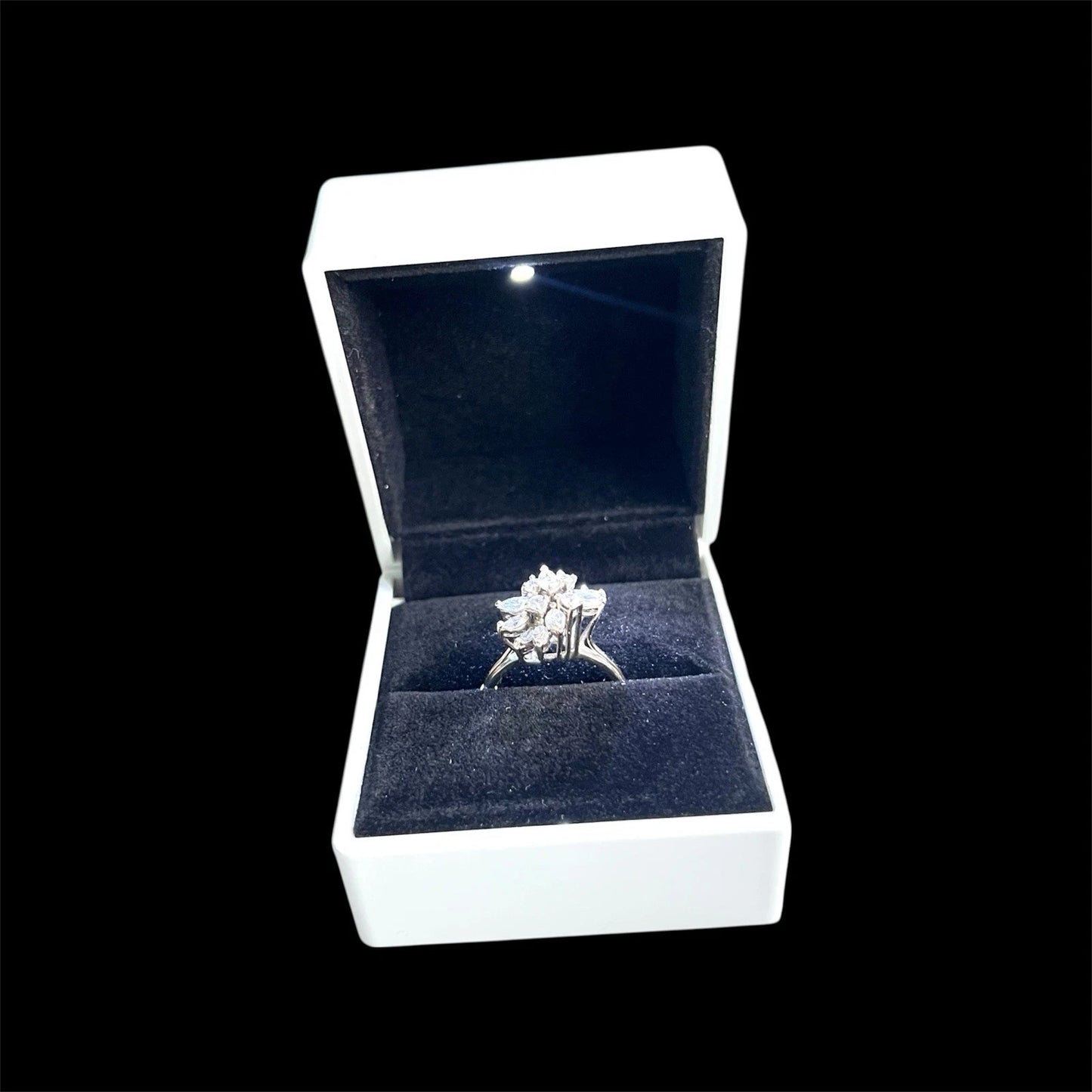 Diamond ring in a white box on a black background