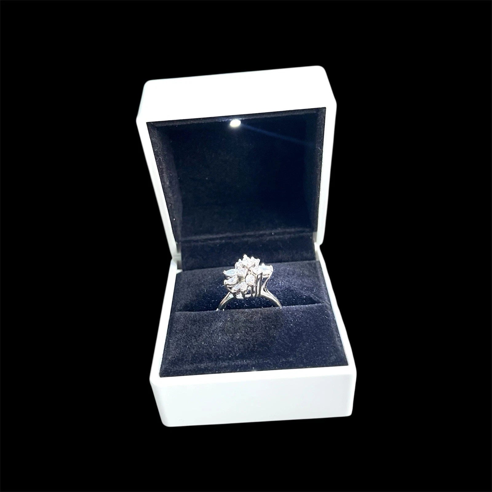 Diamond ring in a white box on a black background
