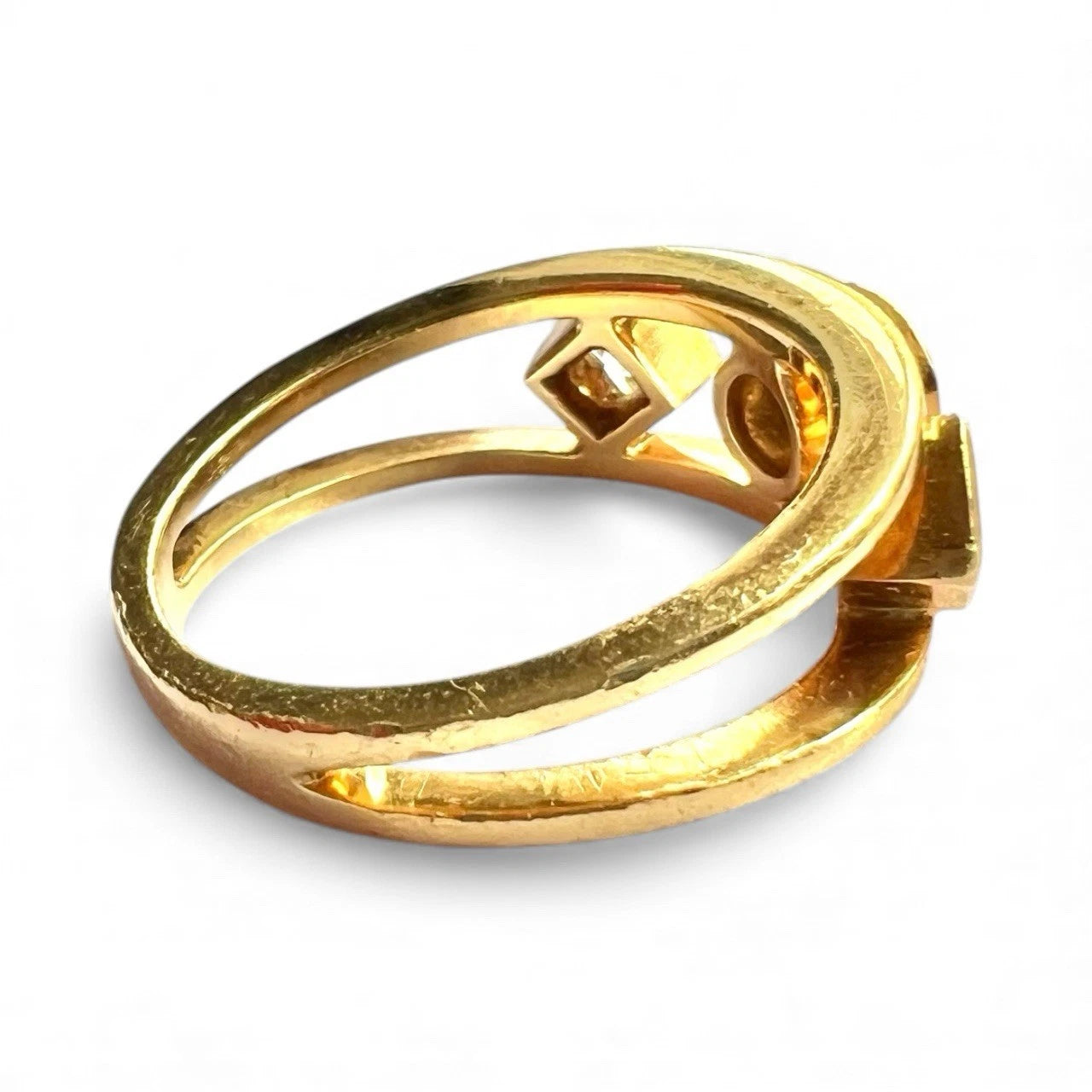 Gold ring with three diamonds on a white background. Close up side view 