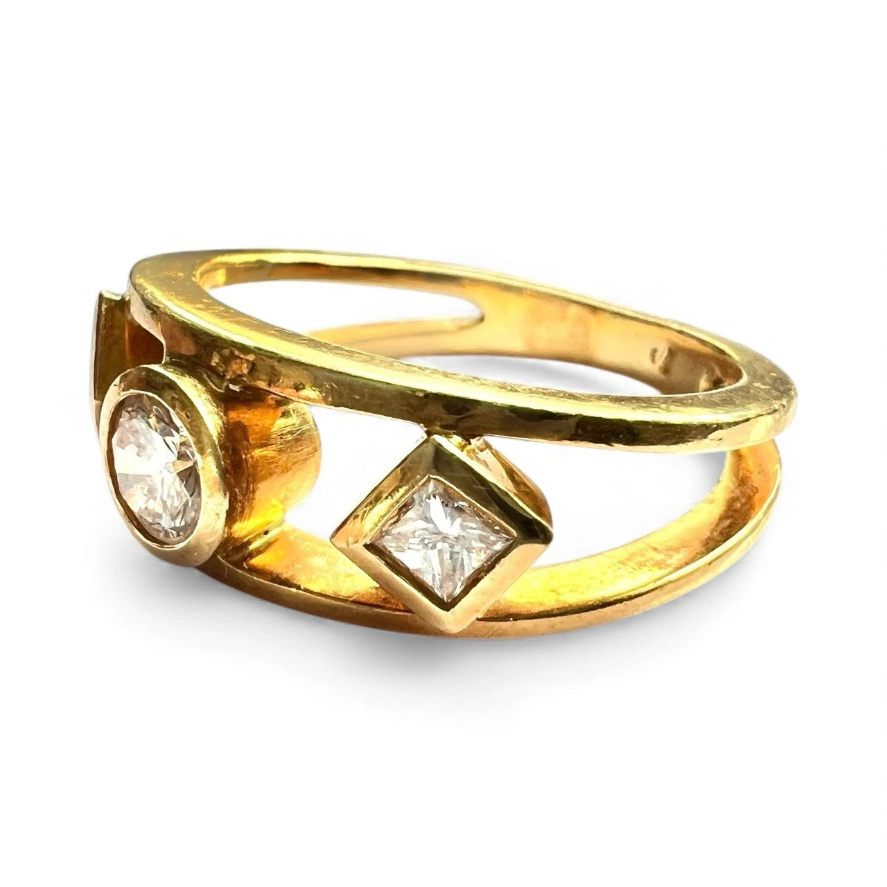 Gold ring with three diamonds on a white background