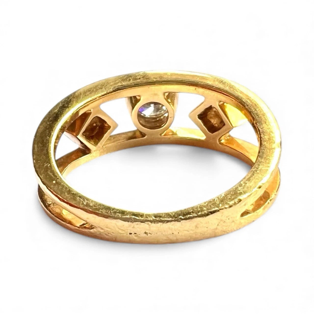 Gold ring with three diamonds on a white background