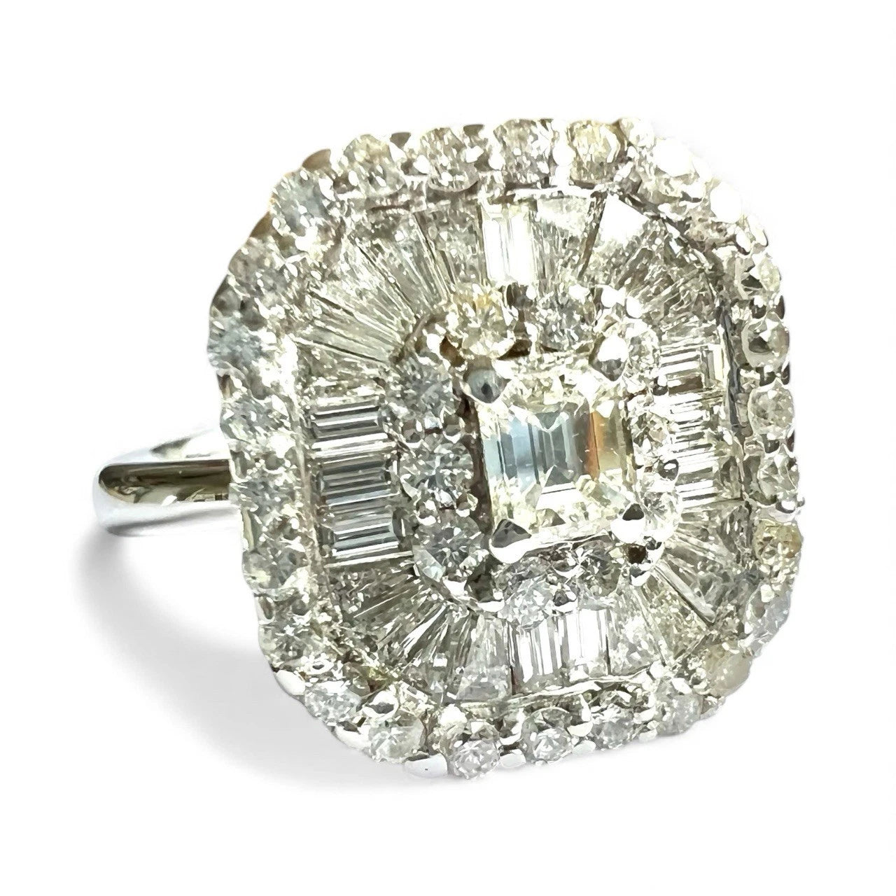 Diamond ring with a central gemstone and smaller stones on a white background