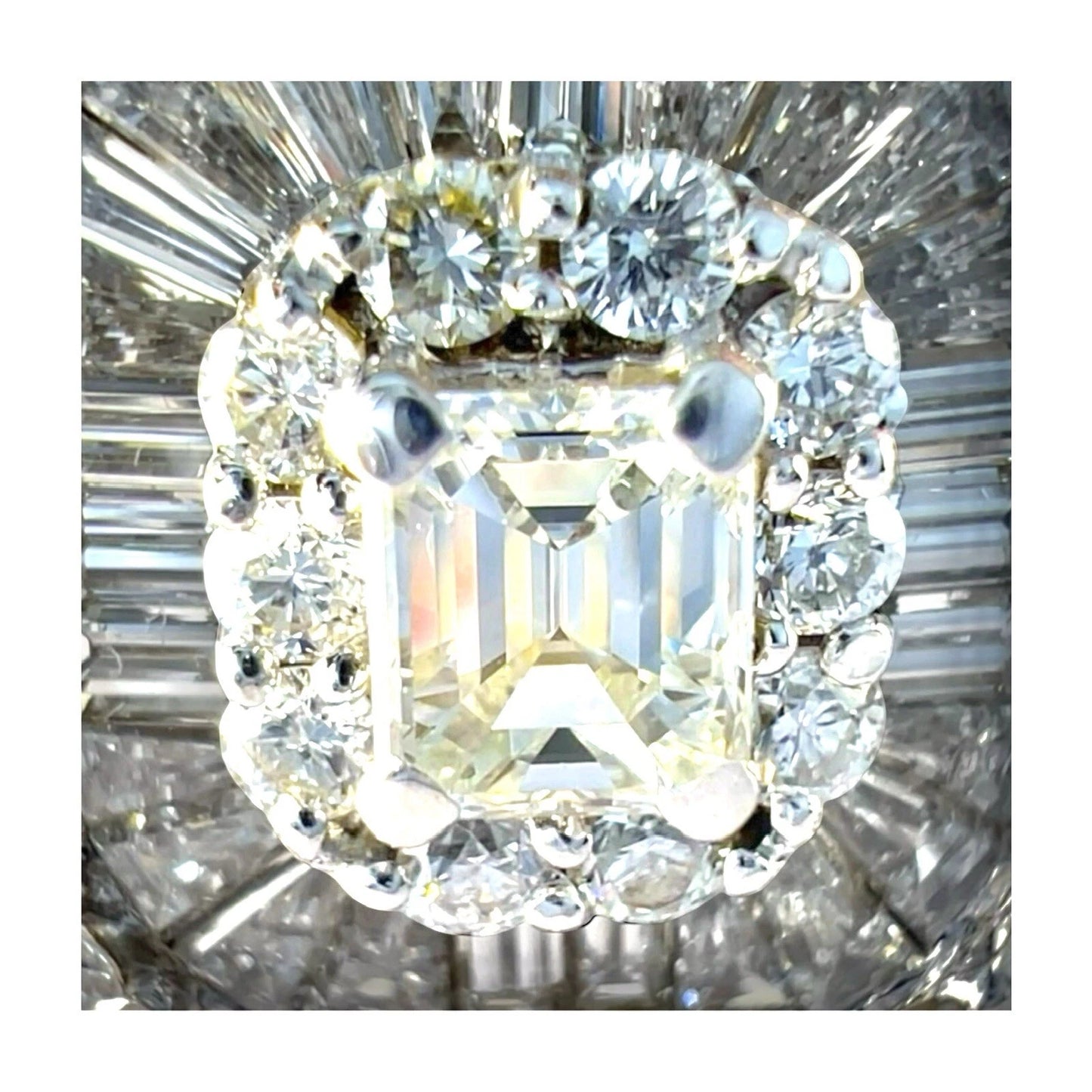 Close-up of a diamond ring with a large central diamond and smaller diamonds around it.