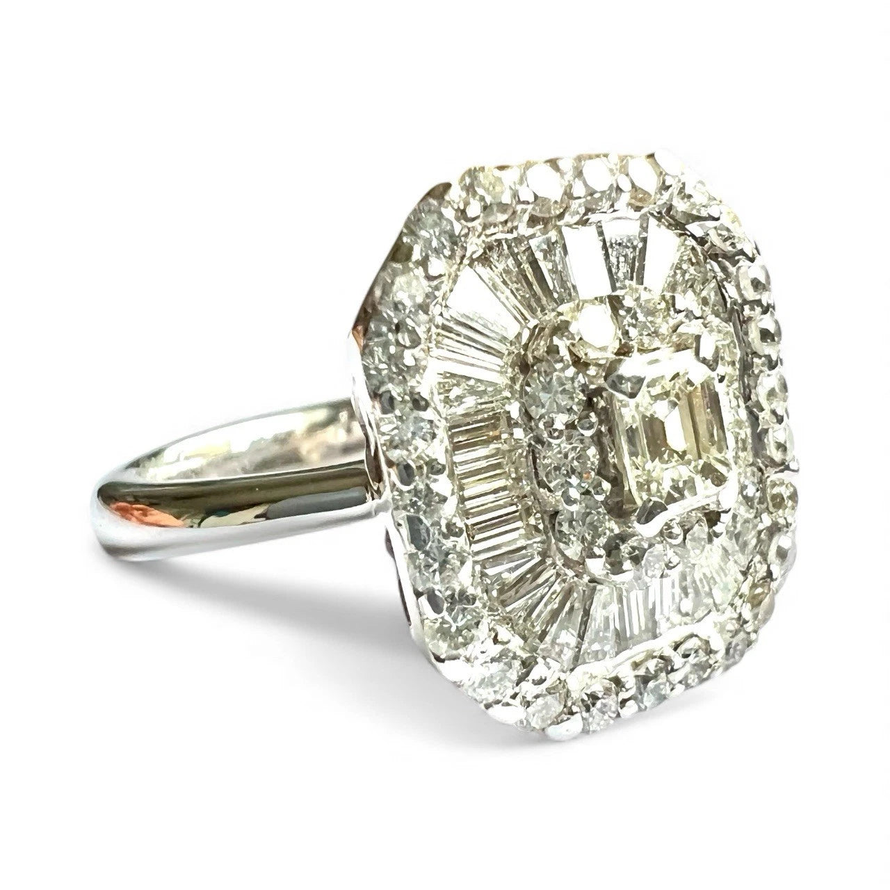 Diamond ring with a large central diamond and smaller diamonds around on a white background