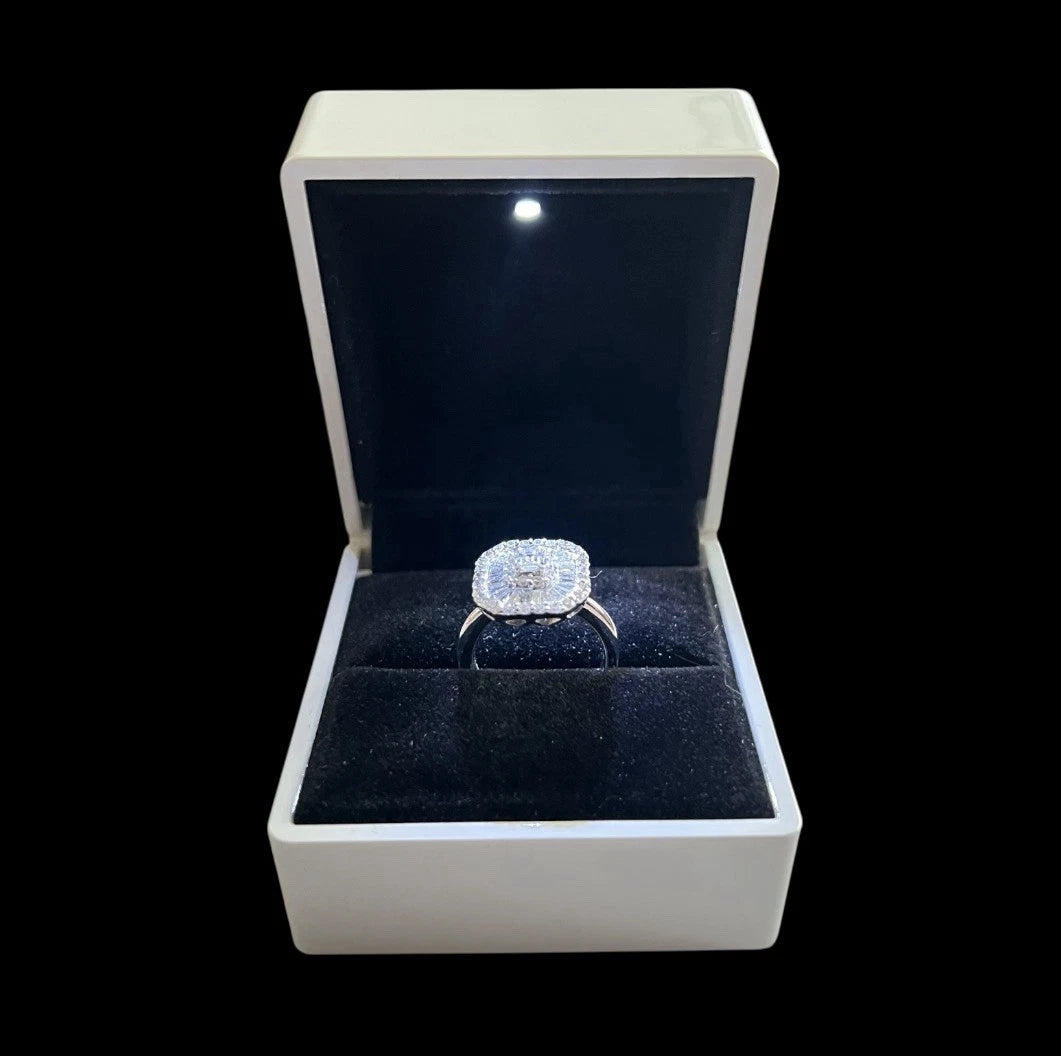 Diamond ring in a white box with a black interior