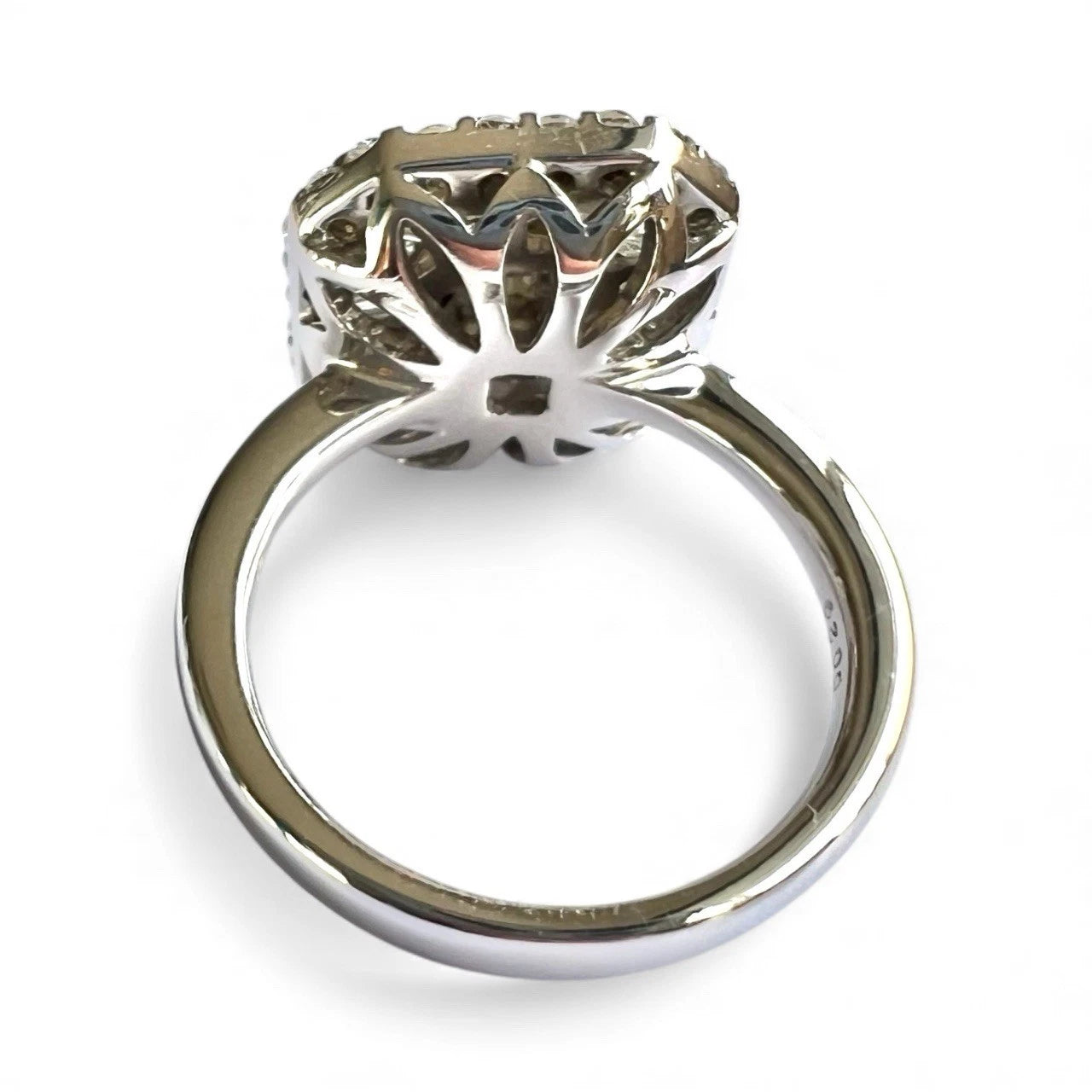 White gold ring with intricate design on a white background