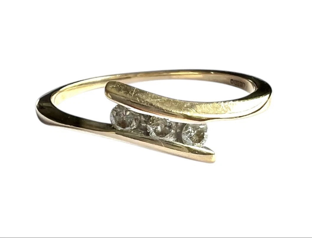 Close up front view Gold ring with three diamonds on a white background 