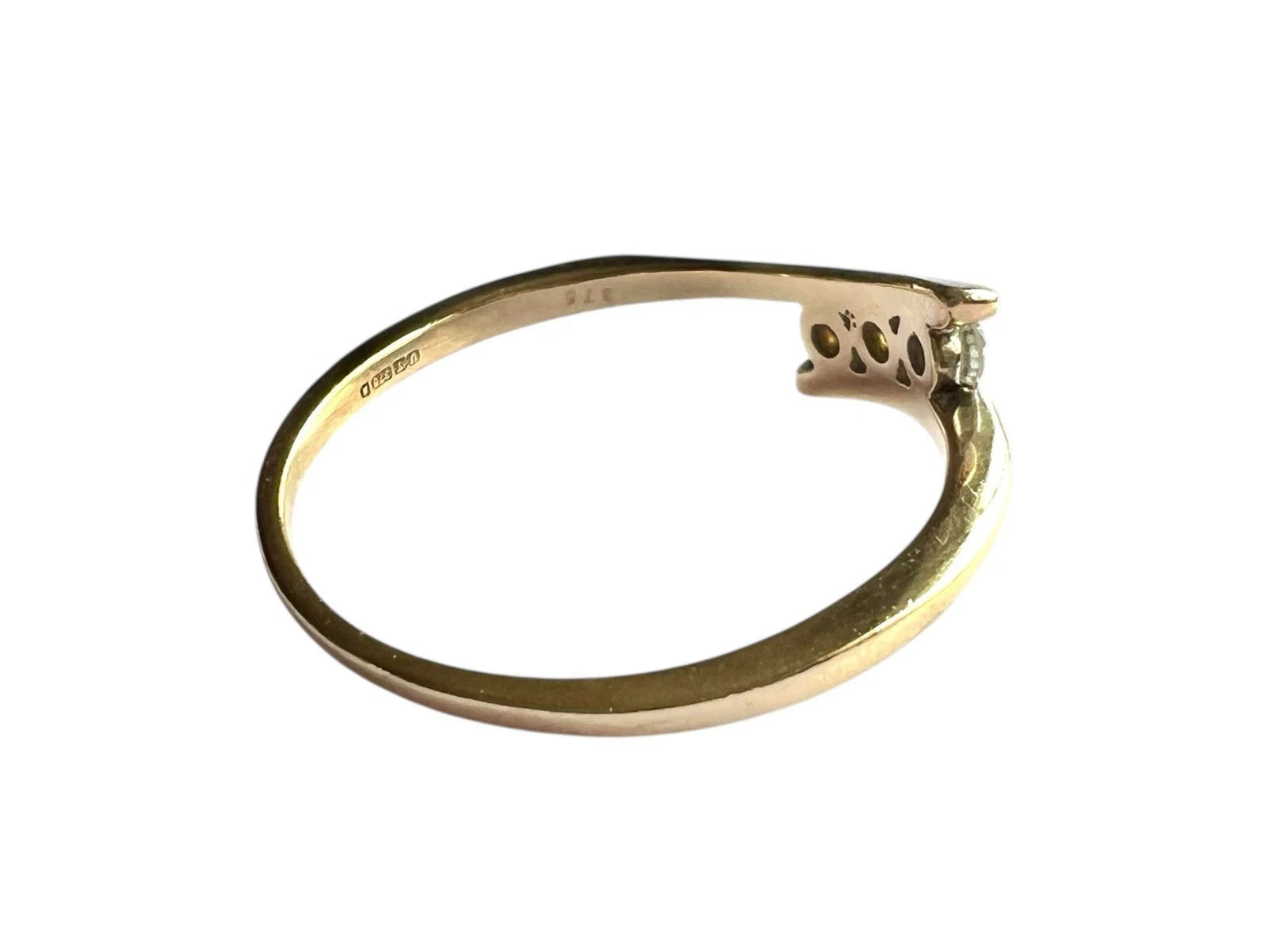 Gold ring with three diamond on a white background