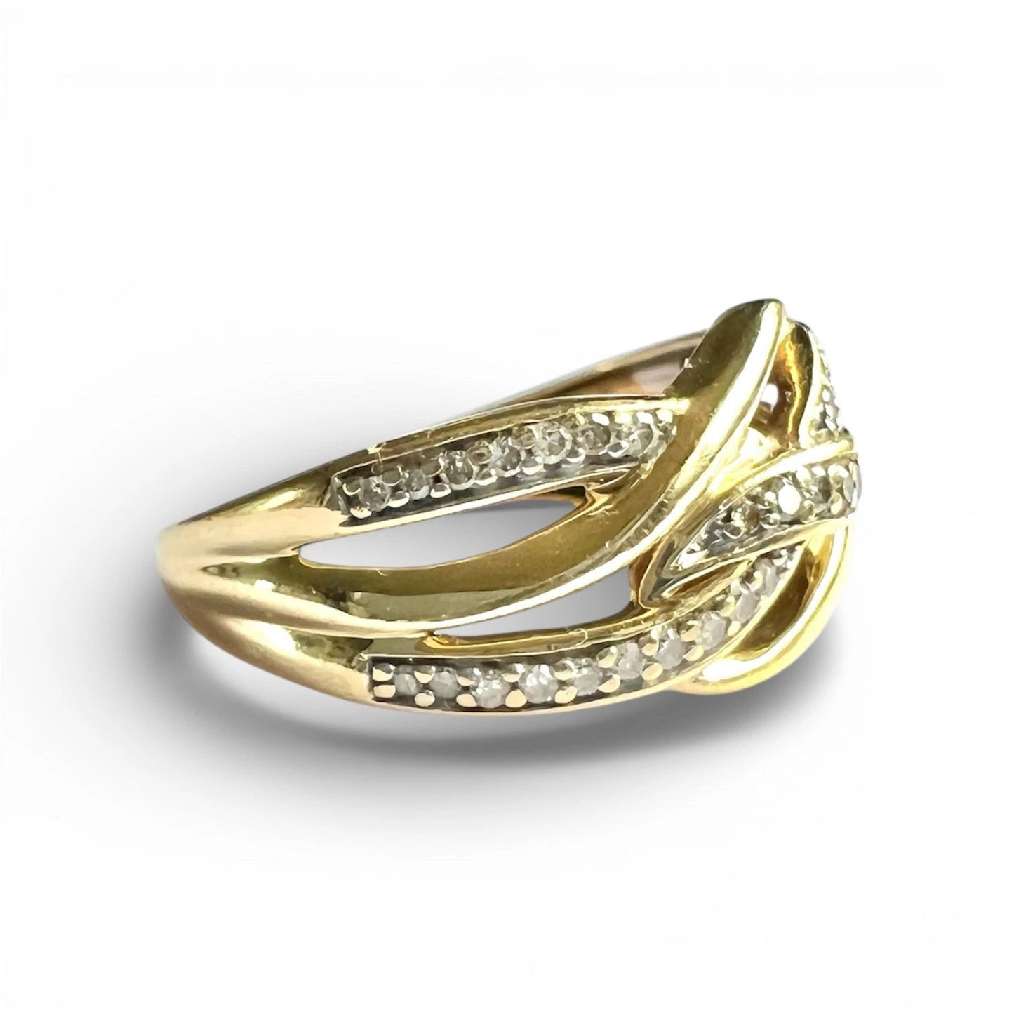close up gold ring with diamond accents on a white background