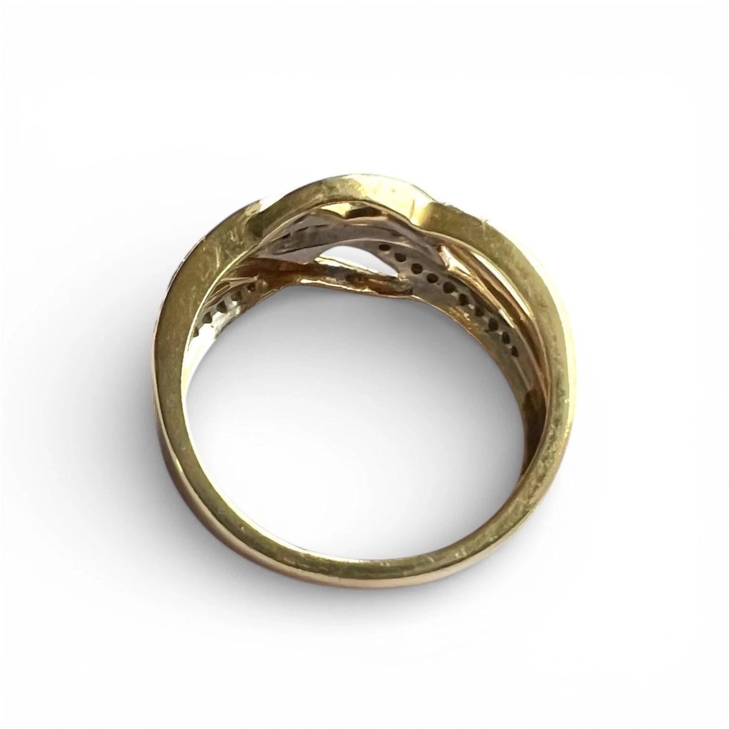Gold ring with a diamonds on a white background top down view