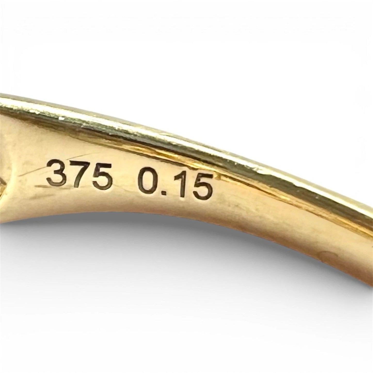 Gold ring with '375 0.15' engraving on a white background