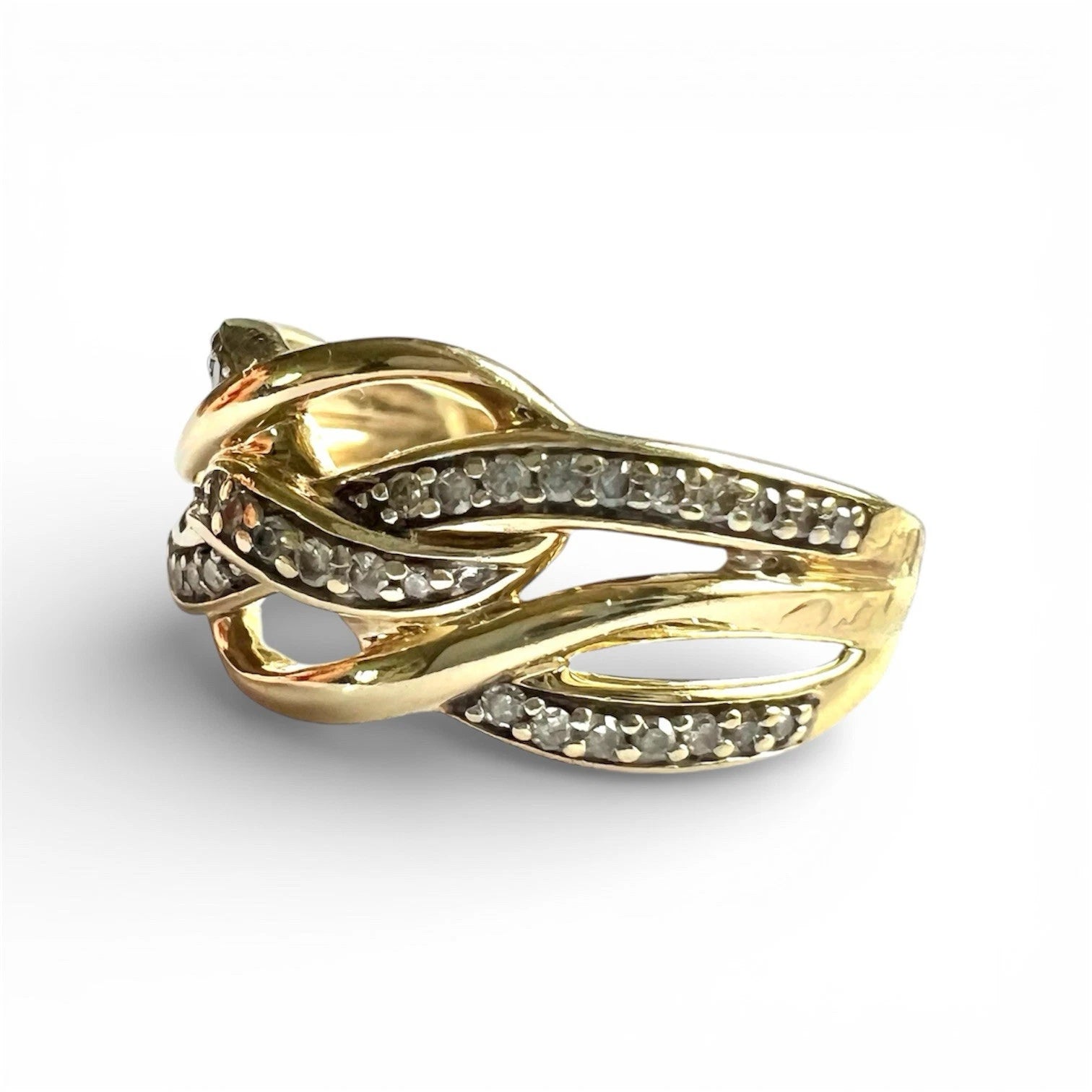 Close up side view of gold ring with diamond accents on a white background