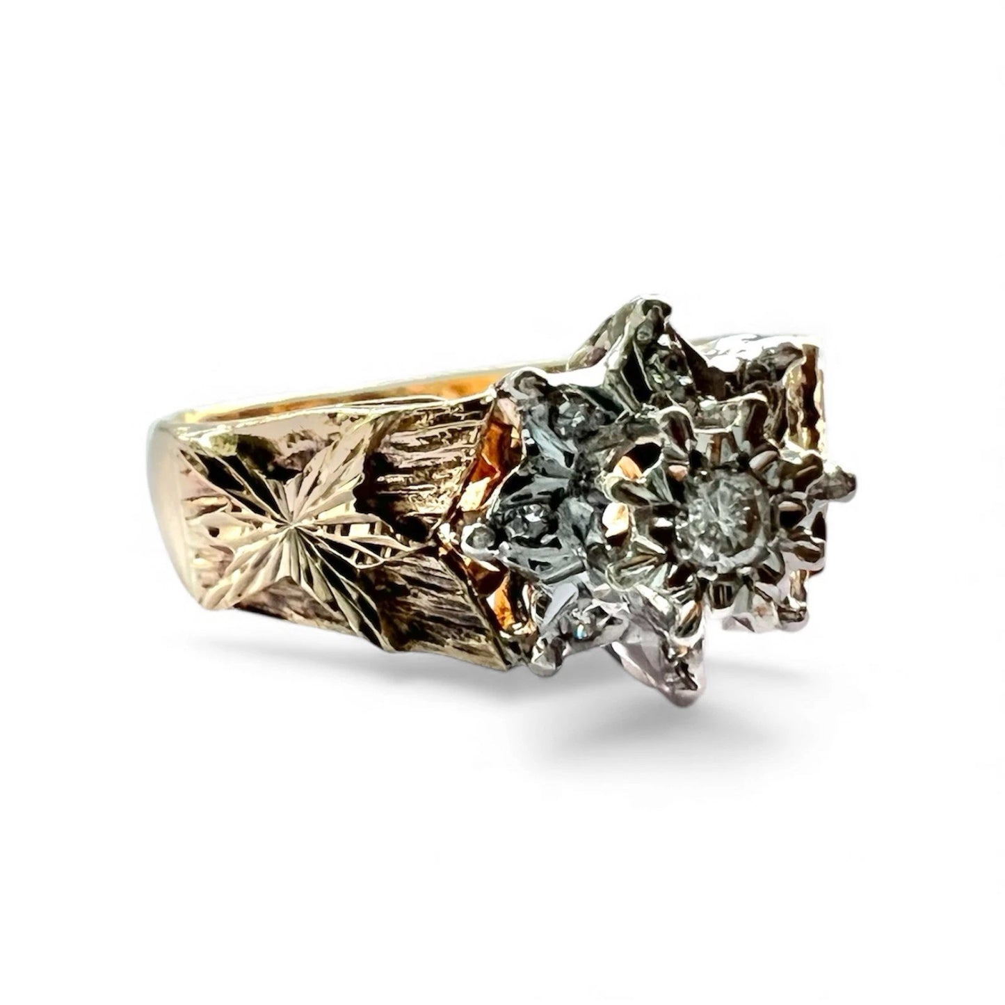 Gold ring with intricate design and embedded gemstones on a white background