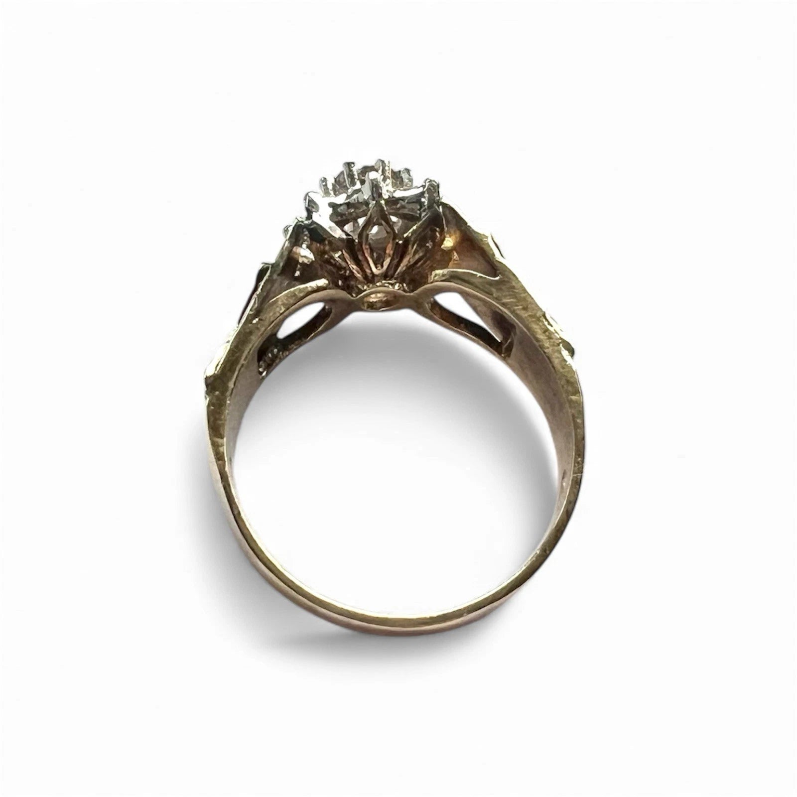 Gold ring with a flower diamond cluster on a white background
