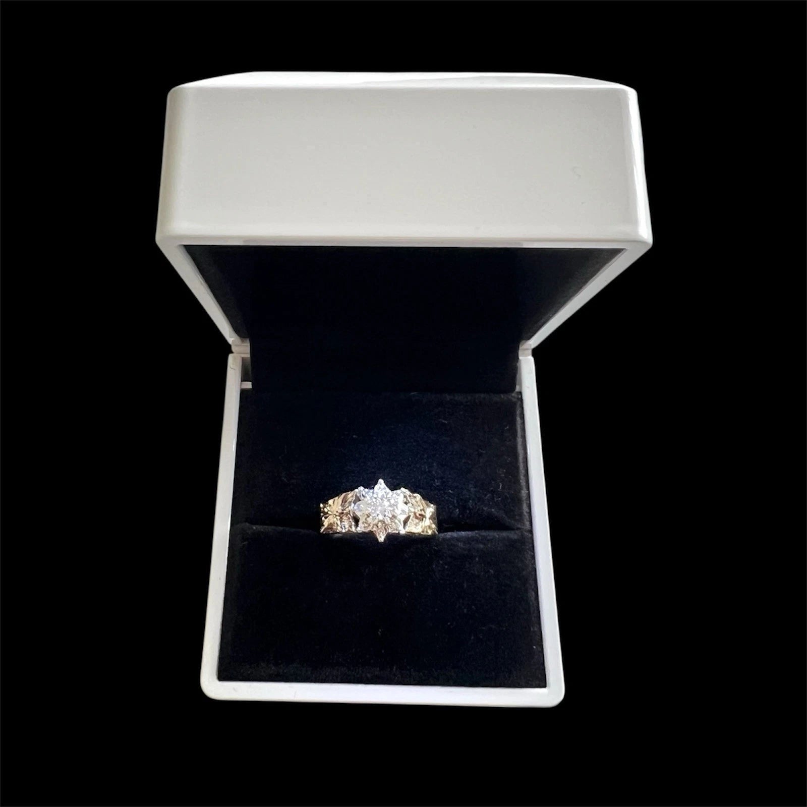 Diamond ring in a white box with a black interior