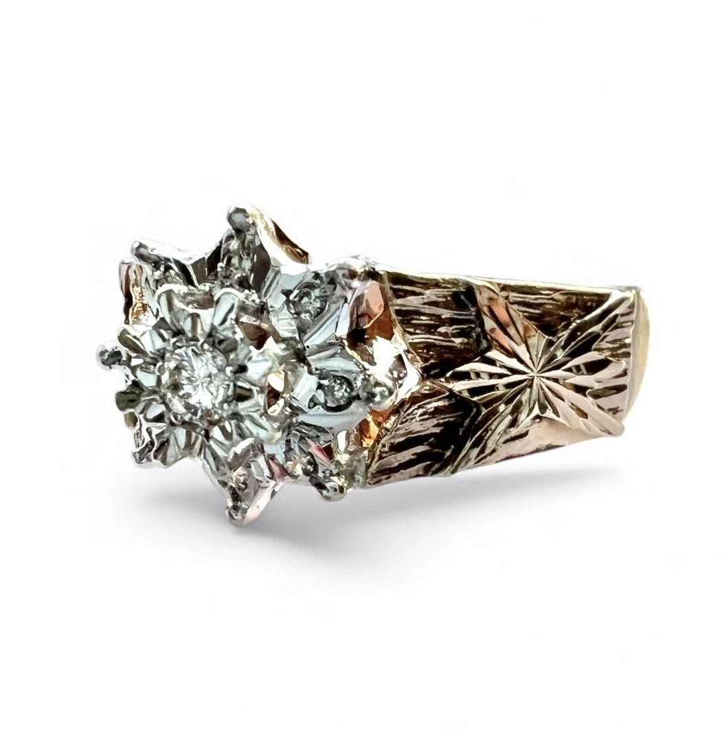 Gold ring with intricate design on a white background