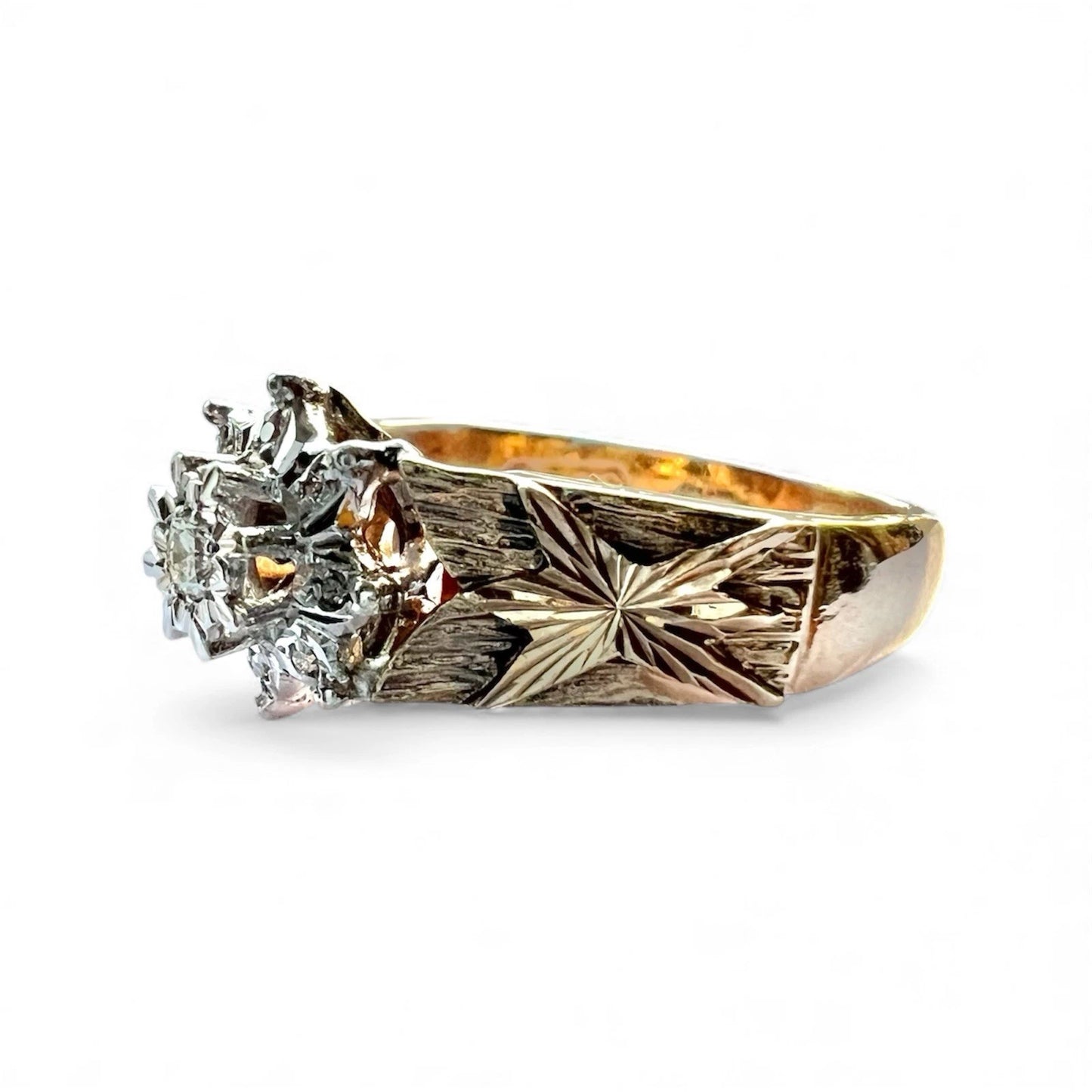 Gold ring with diamond flower cluster on a white background