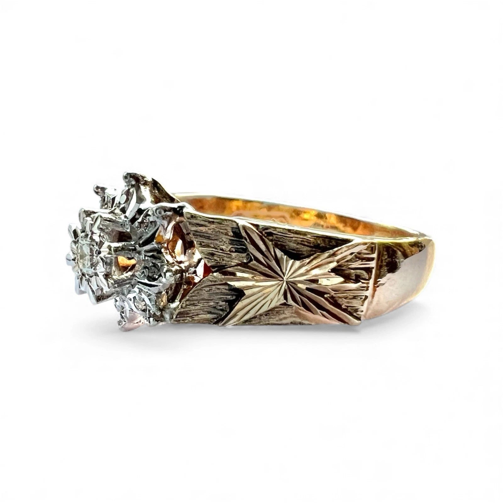 Gold ring with diamond flower cluster on a white background