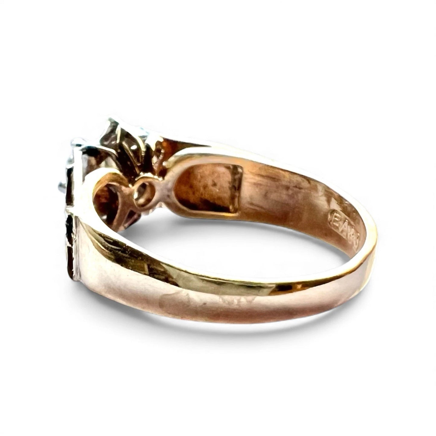 Gold ring with a diamond on a white background
