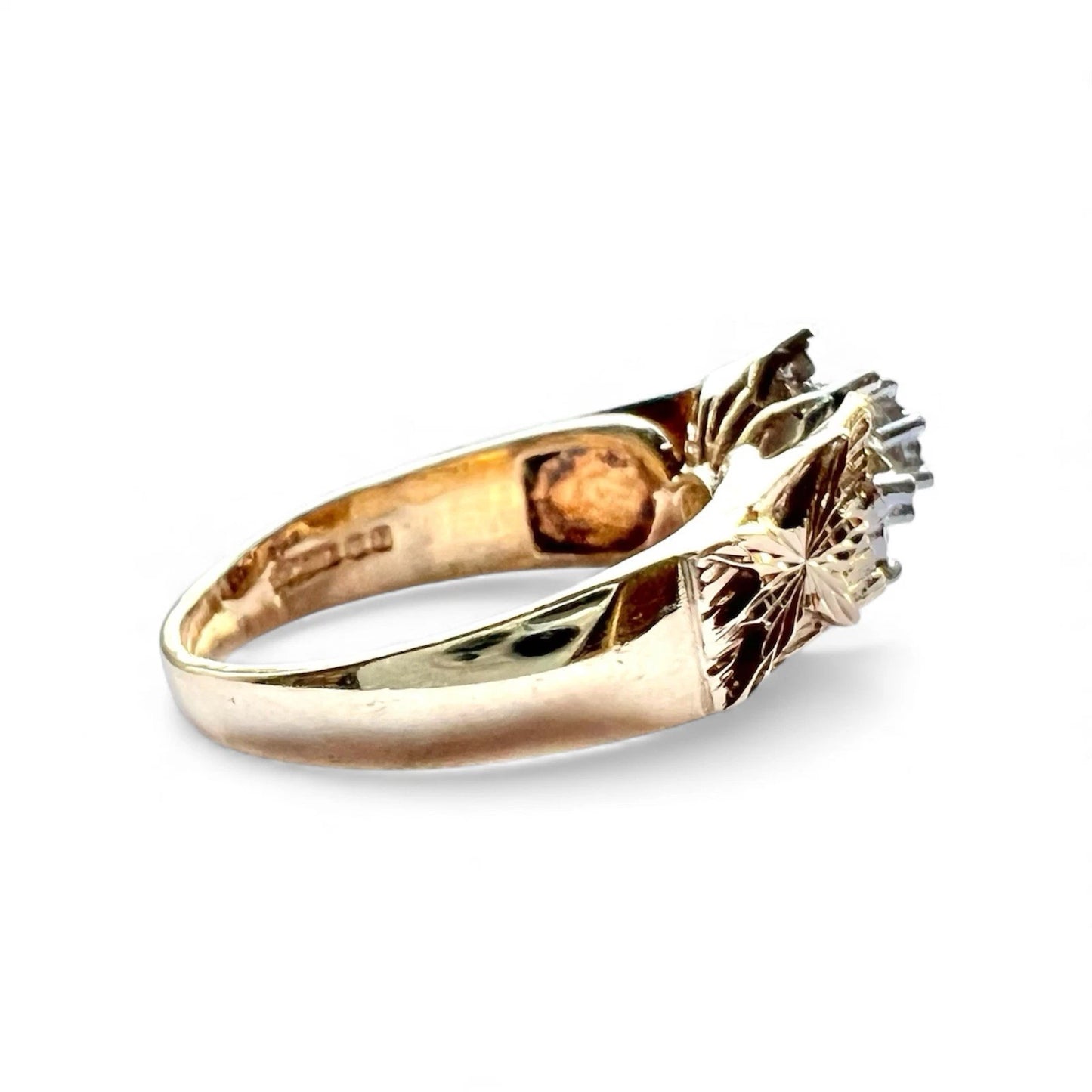 Gold ring with floral design on a white background