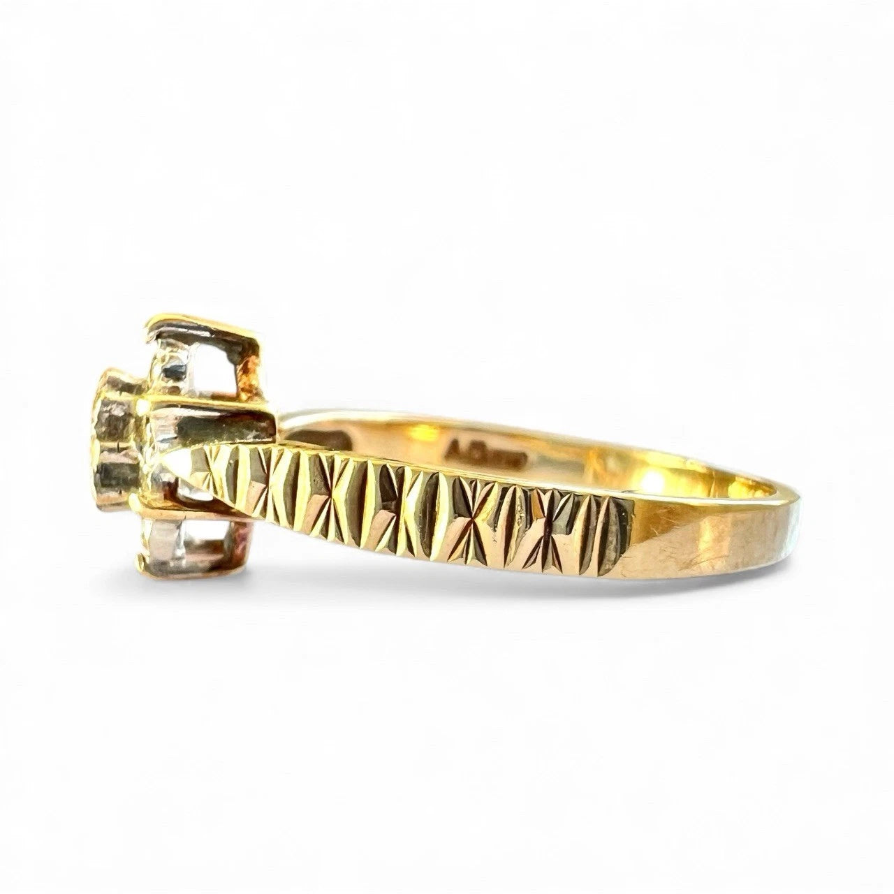 Gold diamond cluster ring with a textured band on a white background