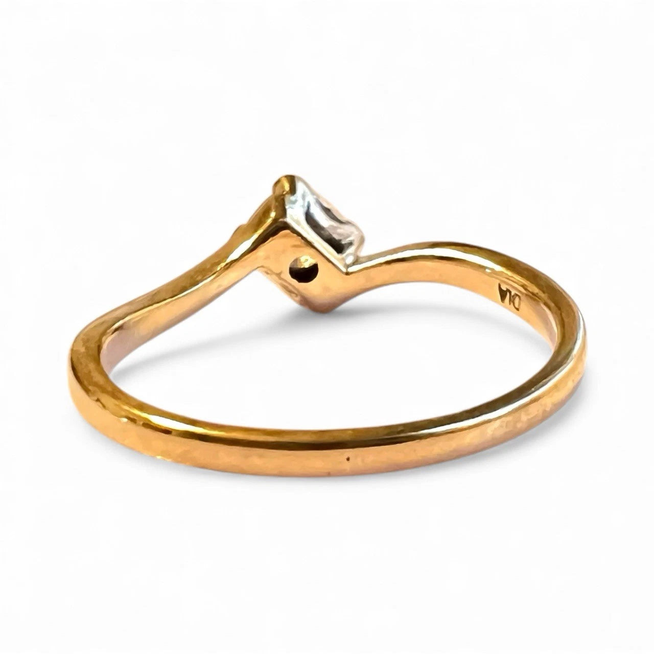 Gold ring with a diamond on a white background
