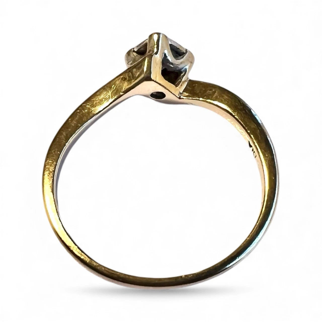 Gold ring with a diamond on a white background