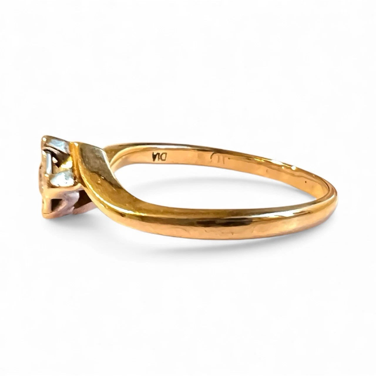 Gold ring with a diamond on a white background