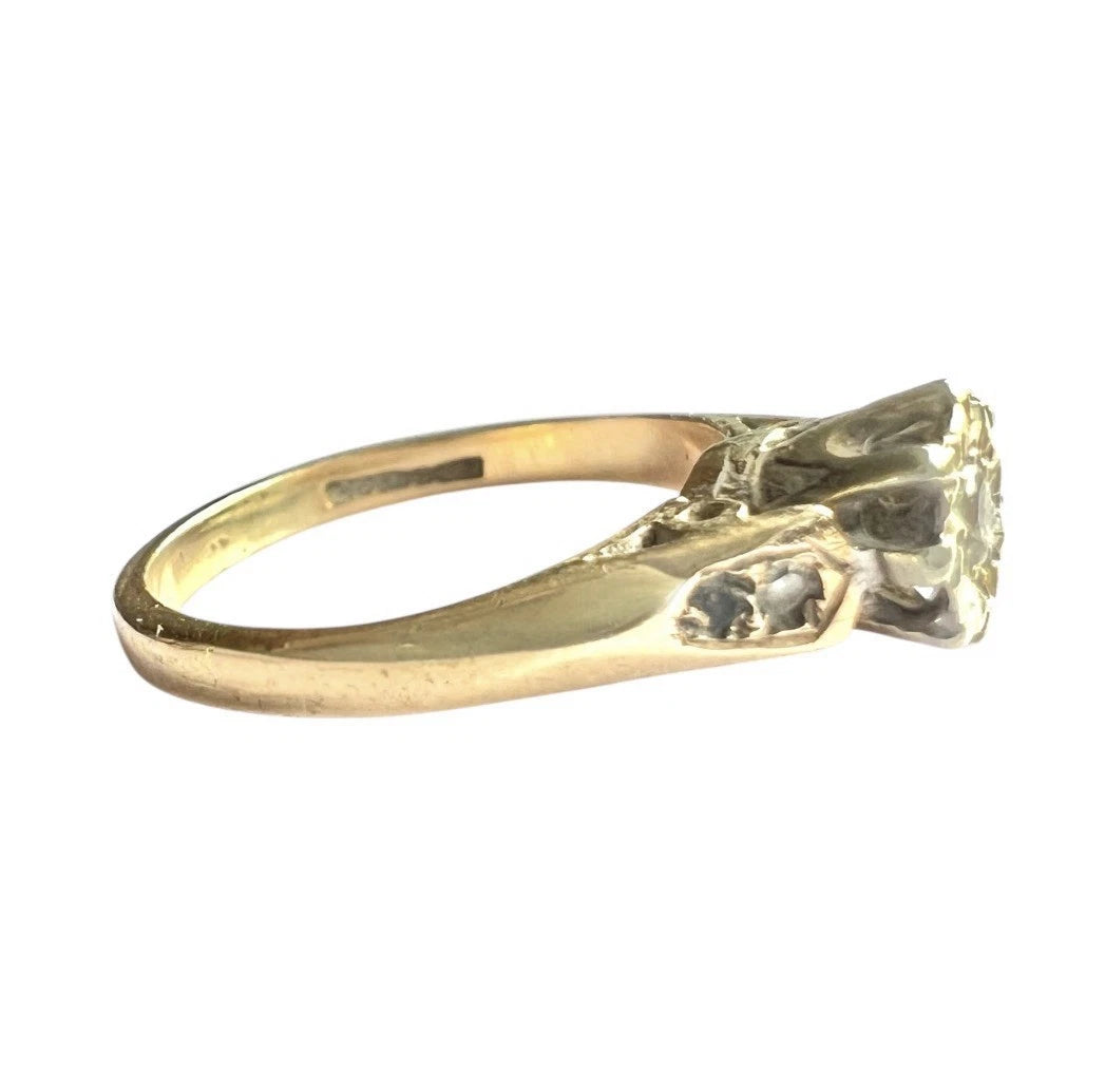 Vintage Gold solitaire ring with a diamond on a white background, side view close-up