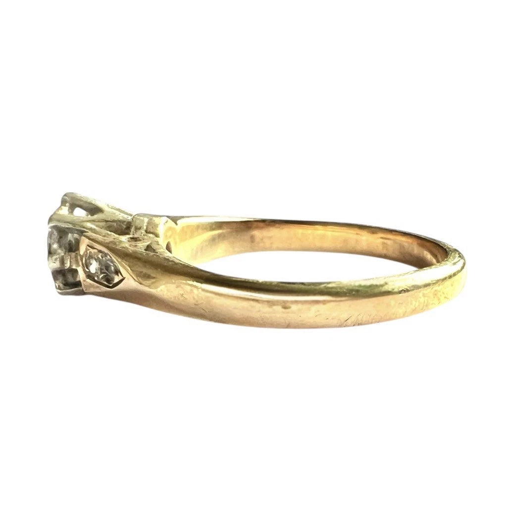 Gold ring with a diamond on a white background, close up side view 