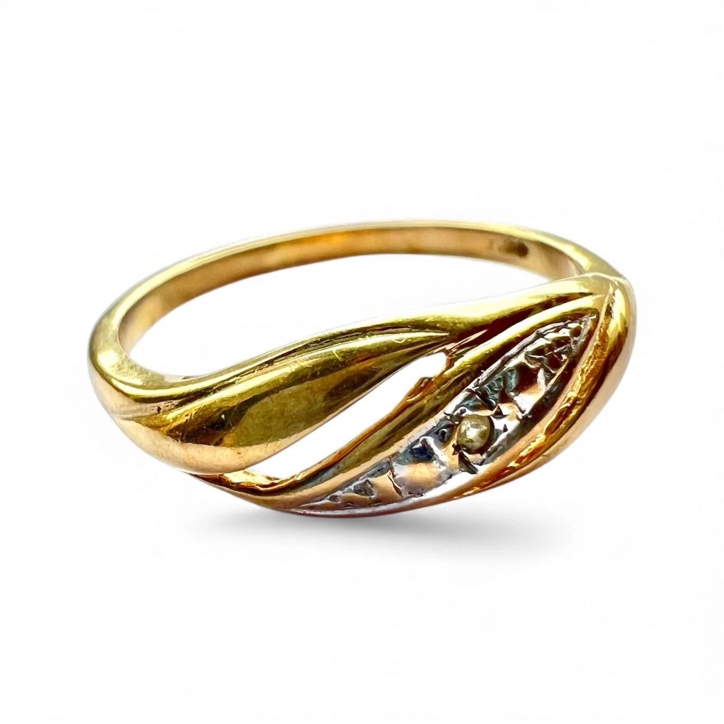 Gold  diamond ring with intricate design on a white background