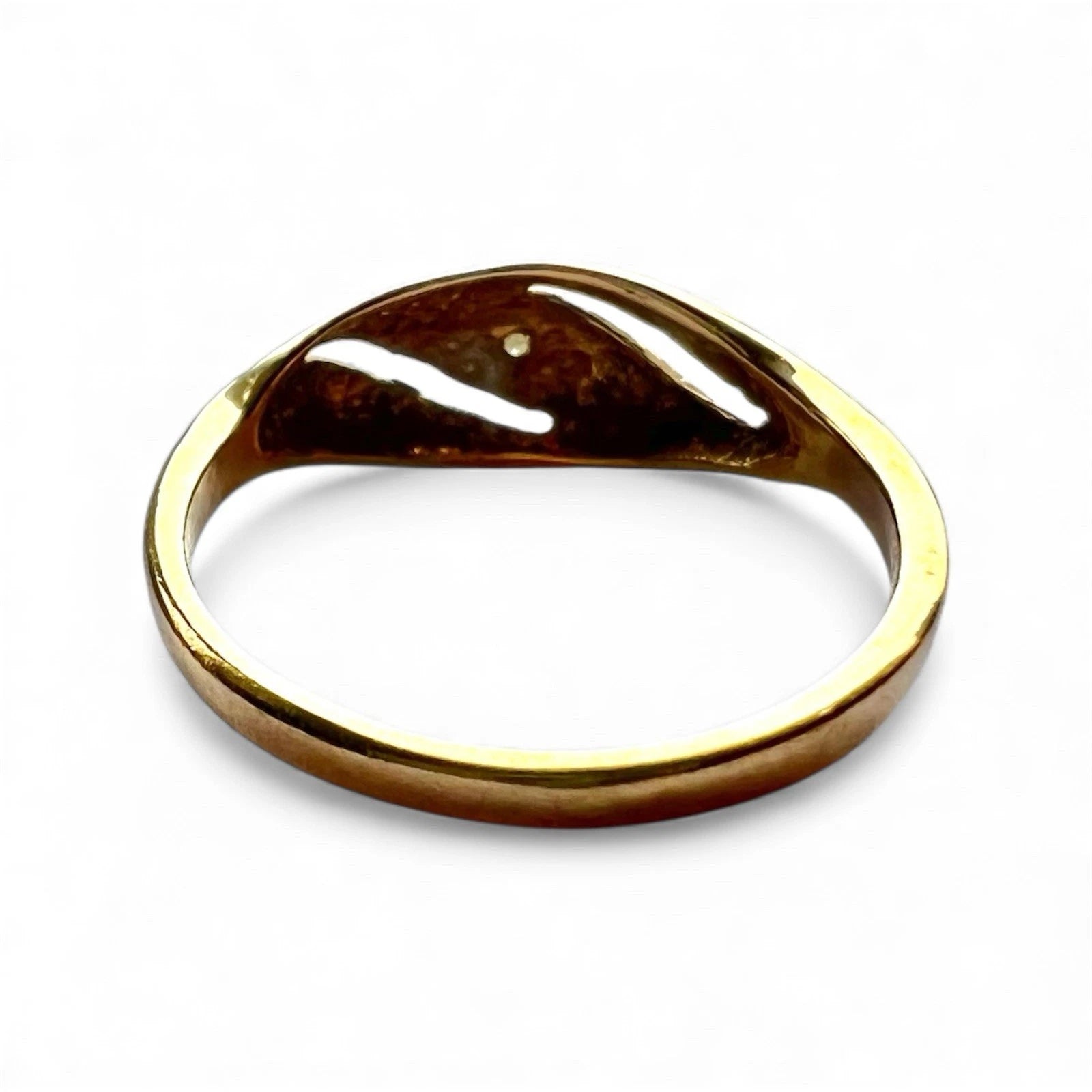 Rear view of gold ring with a unique design on a white background