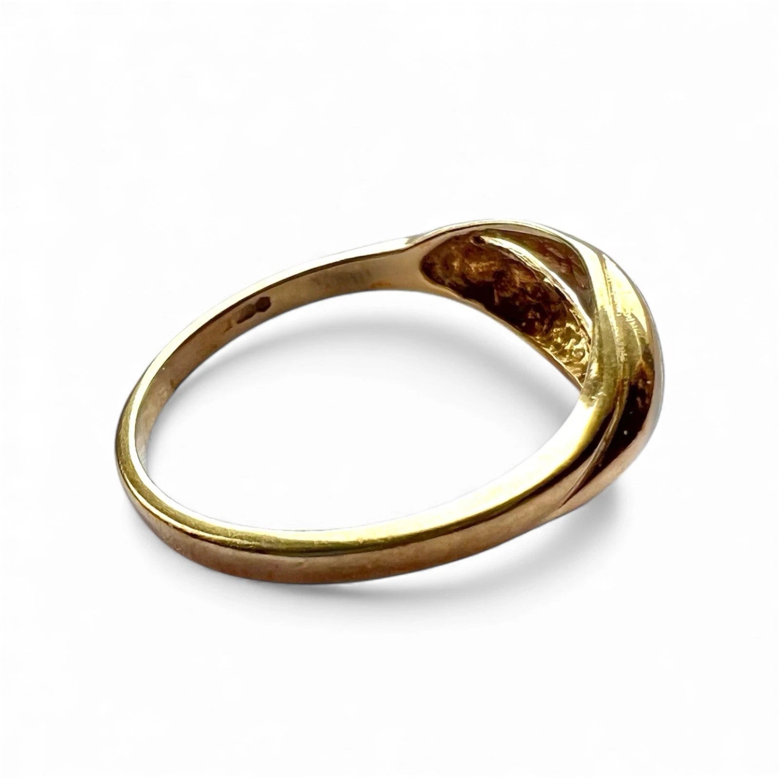 Gold diamond ring on a white background side view 