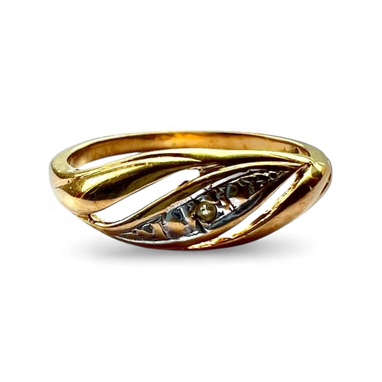 Close up of gold ring with a small diamond on a white background
