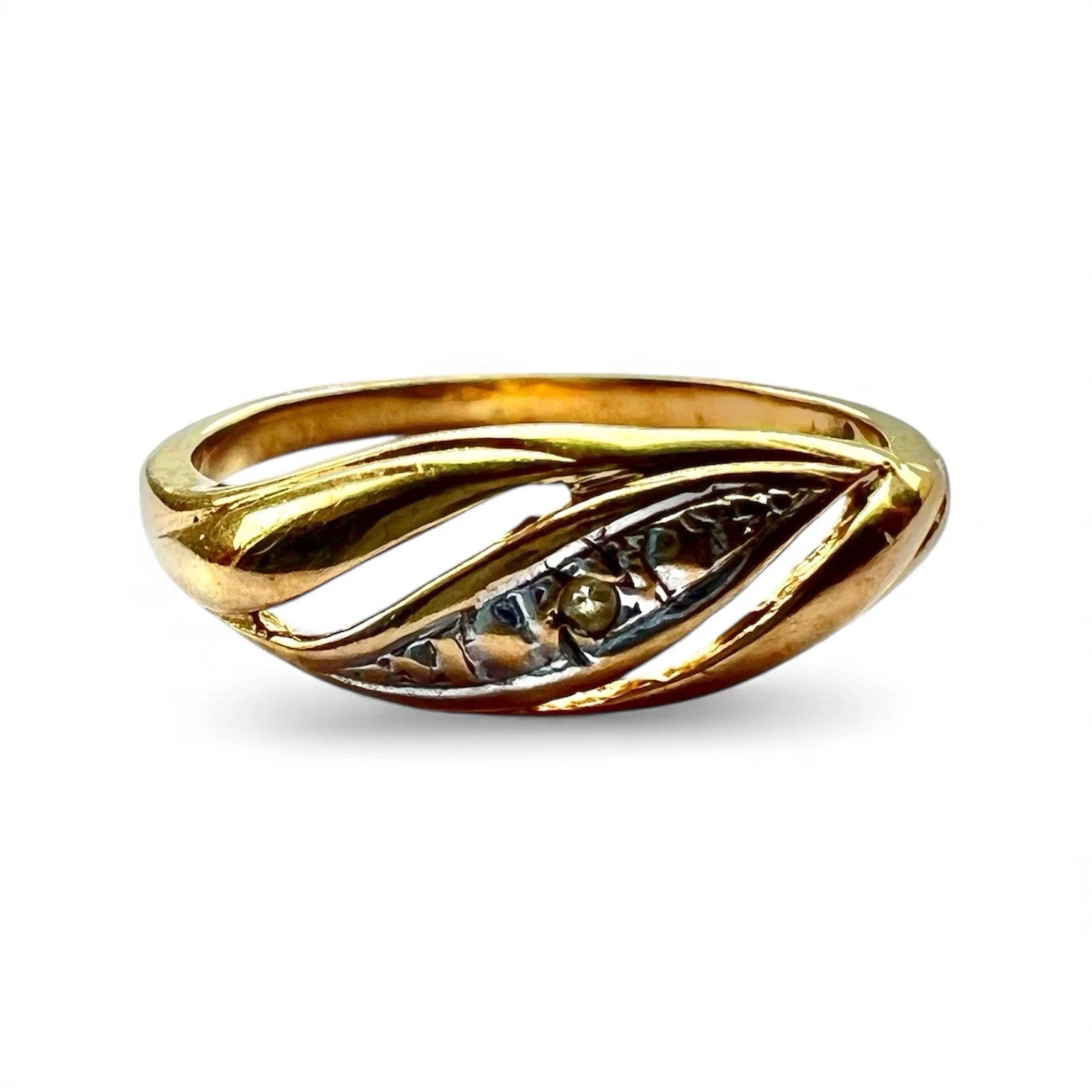 Close up of gold ring with a small diamond on a white background